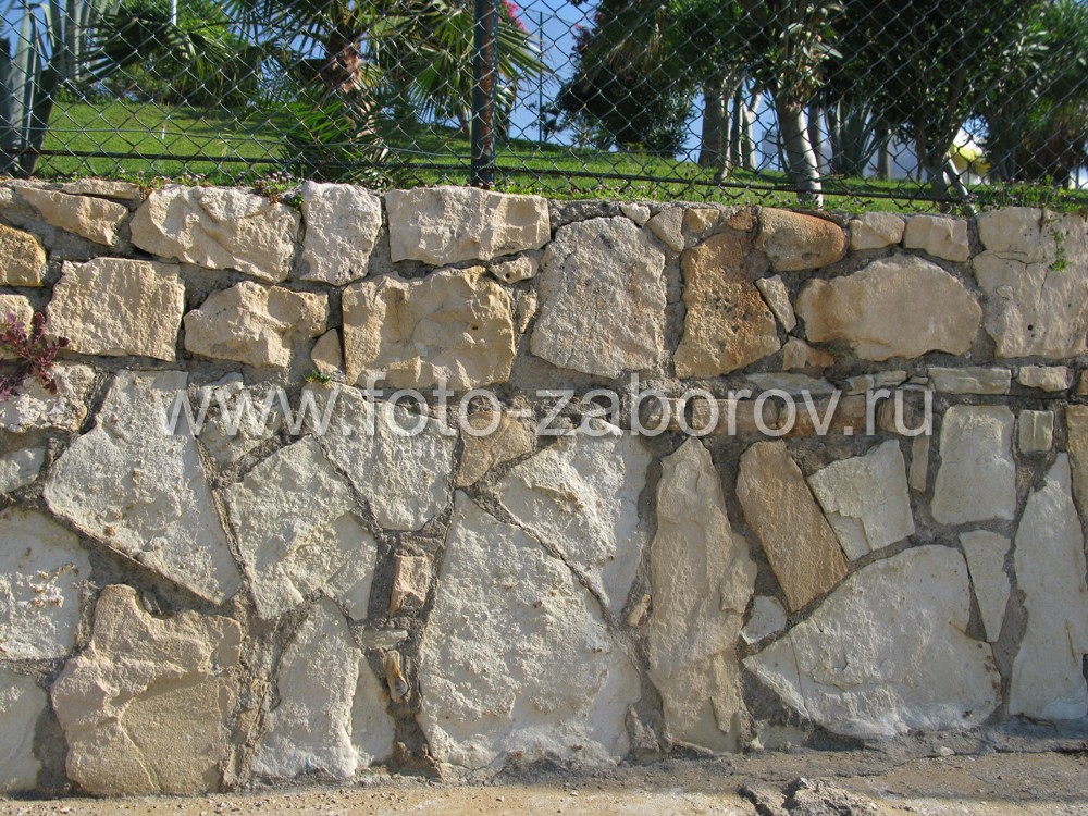 Фото Использование природного камня и высокой сетки-рабицы для ограды